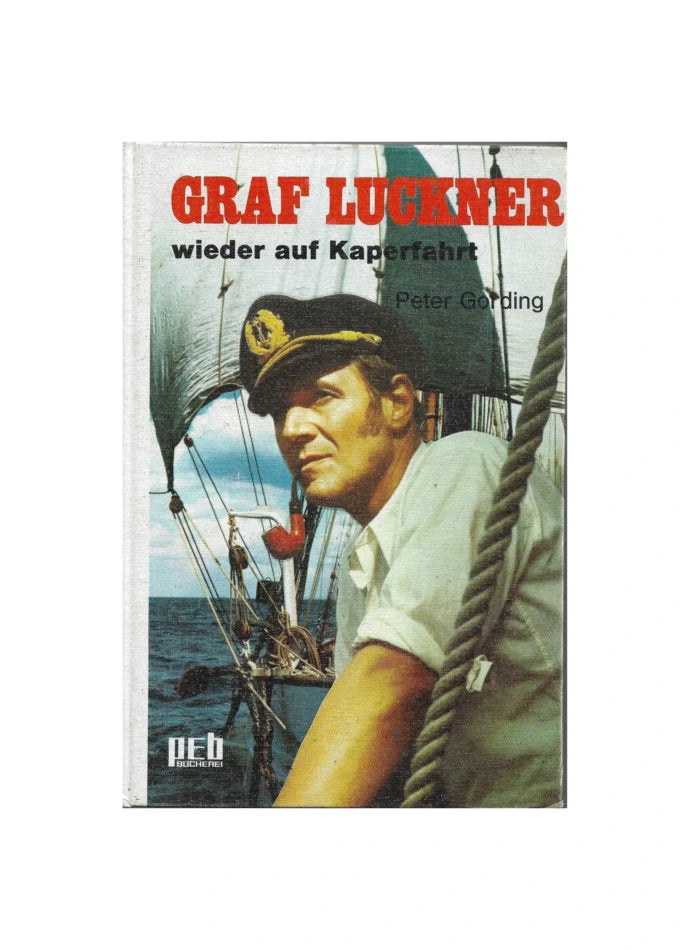 „Buchcover des Jugendromans ‚Graf Luckner wieder auf Kaperfahrt‘ von Peter Gording, Engelbert Verlag 1971. Hardcover mit maritimer Illustration, zeigt ein rotes Auto auf Küstenstraße und ein weißes Haus auf einer Klippe.“