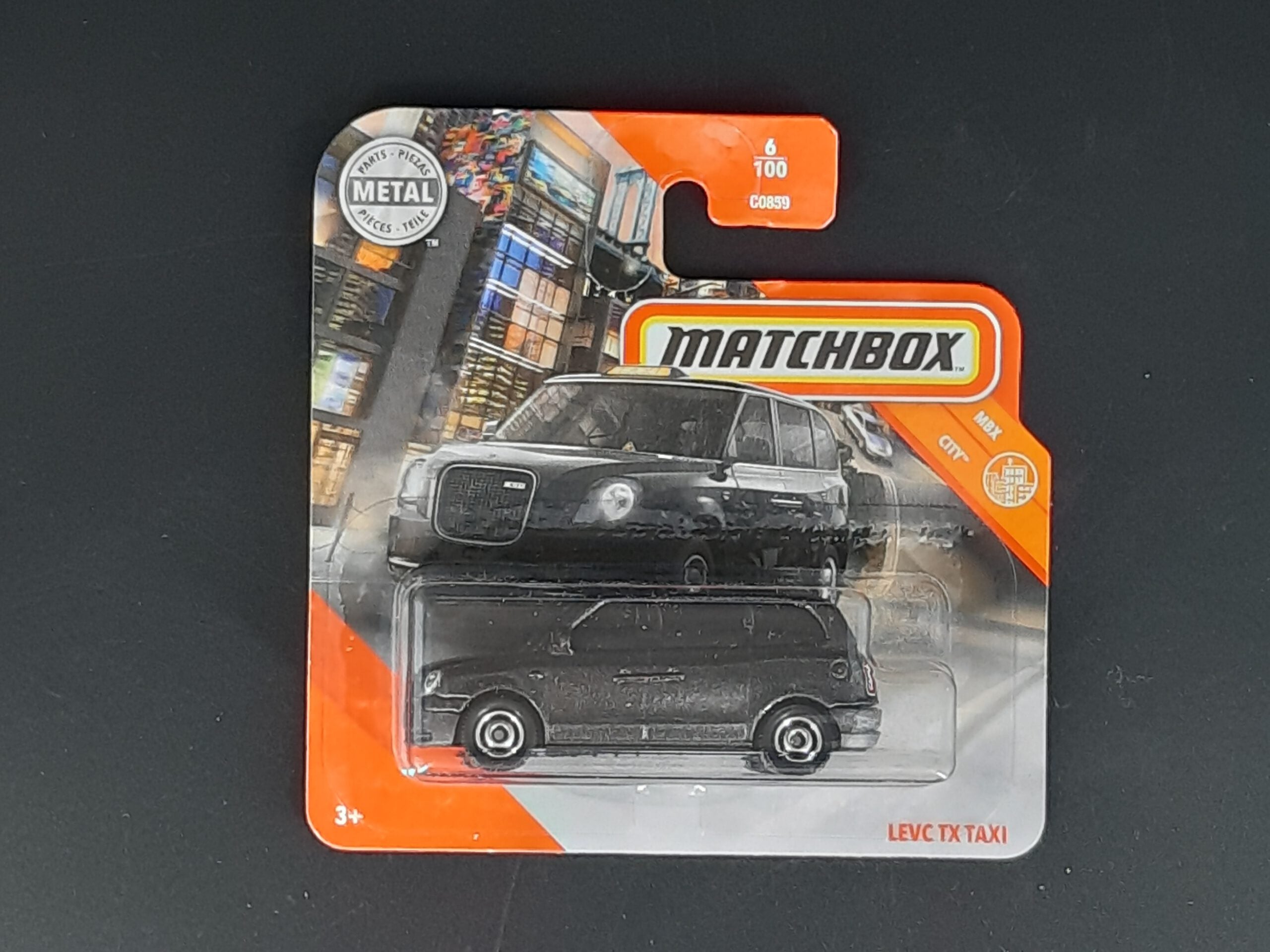 Matchbox LEVC TX Taxi MBX City 6/100, schwarzer Metall‑Druckguss, ca. 6,5×3×2,5–3,5 cm – neues Sammlermodell in OVP im Maßstab 1:64.