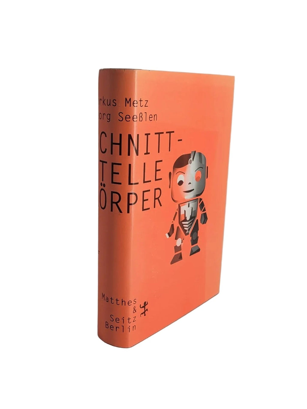 Buchcover des Sachbuchs „Schnittstelle Körper“ von Markus Metz und Georg Seeßlen, erschienen bei Matthes & Seitz Berlin, in leuchtendem Orange mit einer Roboter-Figur.