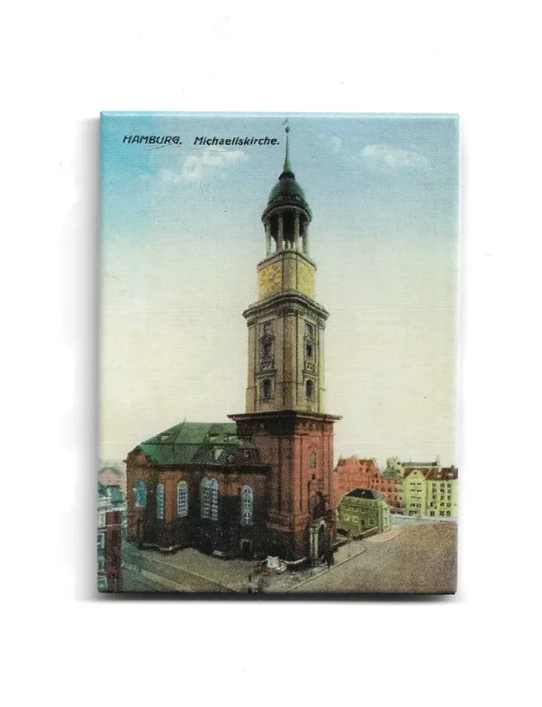 „Magnet mit farbiger Illustration der Hamburger Michaeliskirche. Zeigt barocken Kirchturm mit Kupferdach und Uhr, umgeben von Stadtgebäuden. Text: ‚Hamburg. Michaeliskirche.‘“